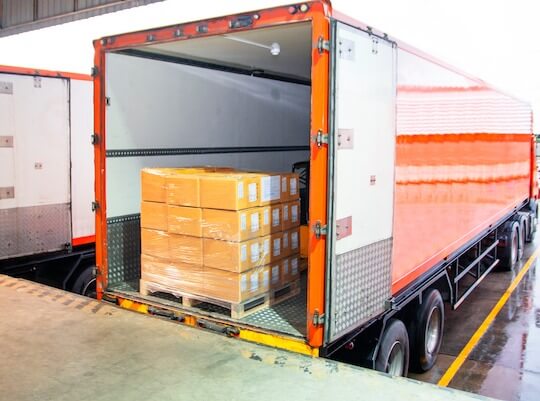 haulage vehicles being loaded with freight