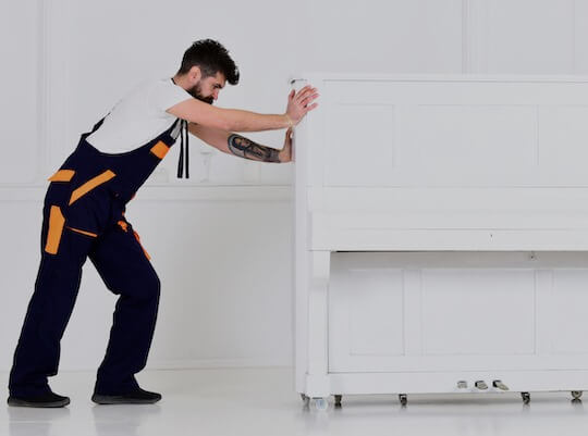 man performing a piano removal service