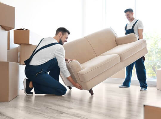 men unloading furniture from a van