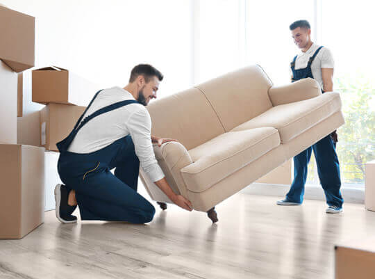Man loading furniture into a van for shipping